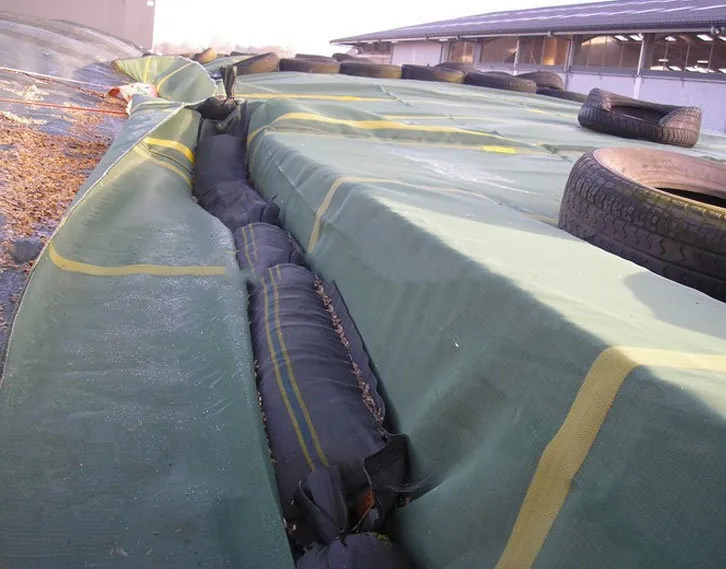 Silo gravel bags reinforcing a silage pit cover 2